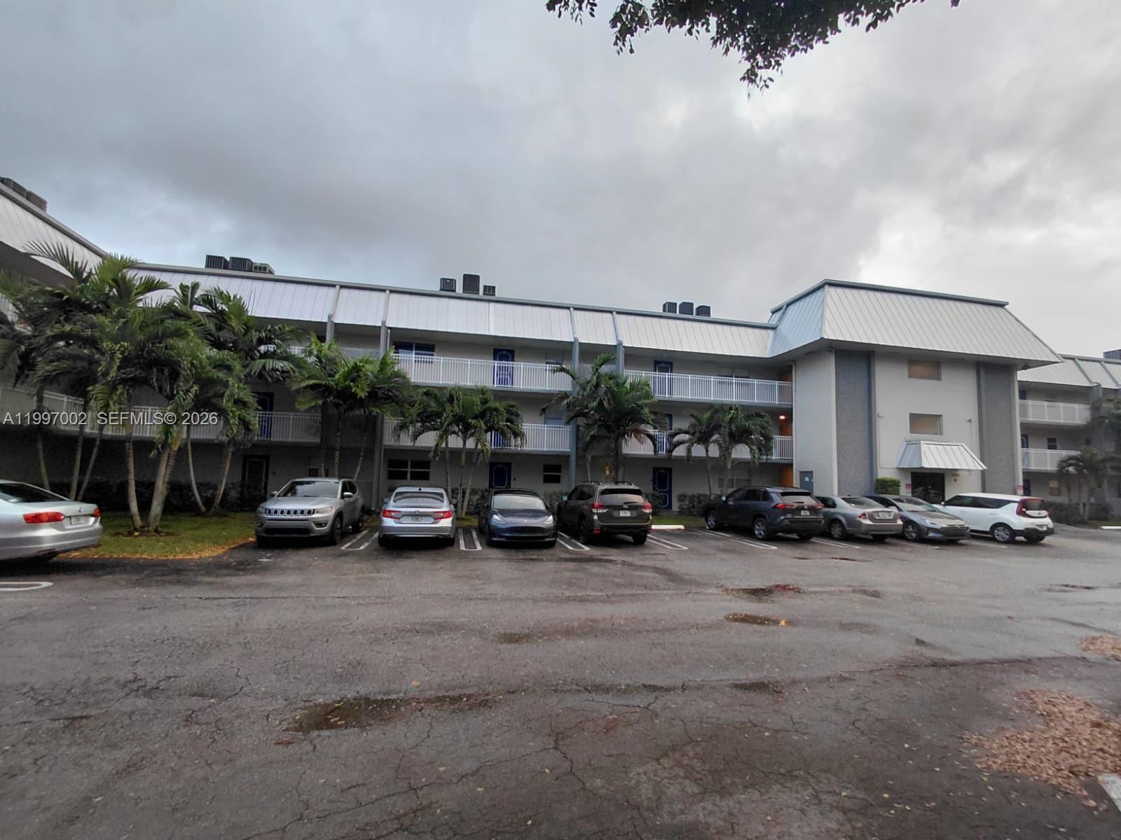2980 Riverside Drive, Unit 1253 Coral Springs, FL 33065 - Photo 2 of 18 a view of parking garage with cars