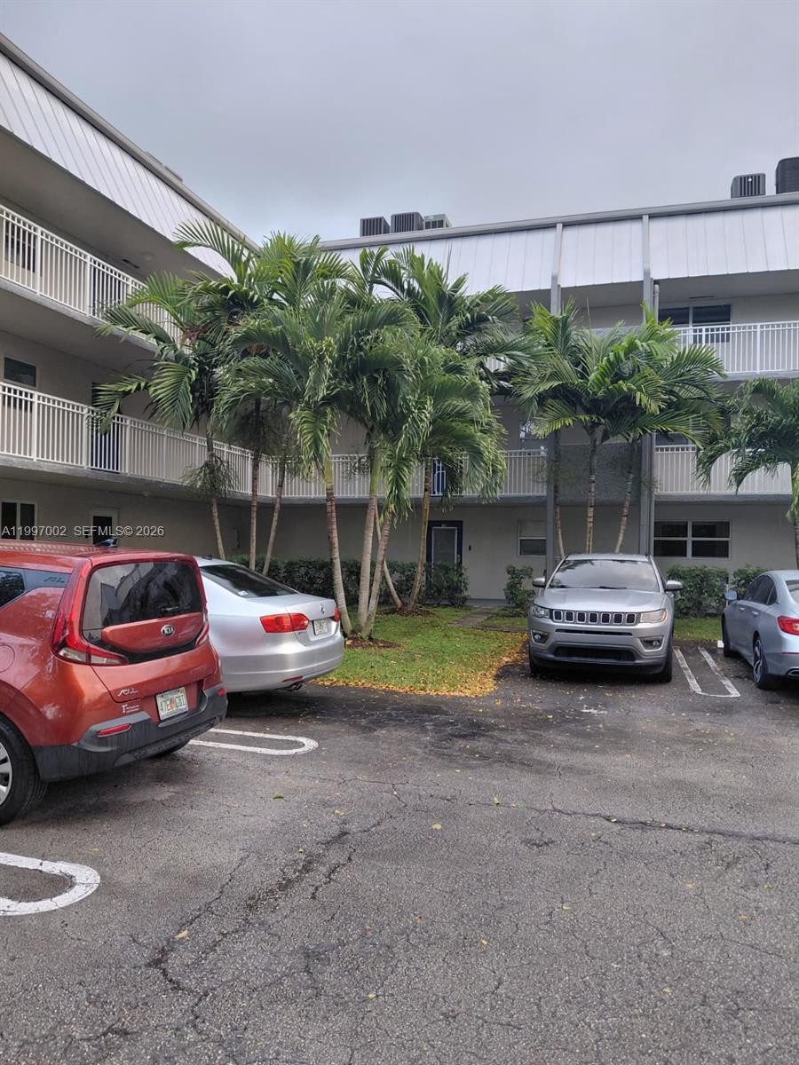 2980 Riverside Drive, Unit 1253 Coral Springs, FL 33065 - Photo 3 of 18 a view of a cars parked in front of a building