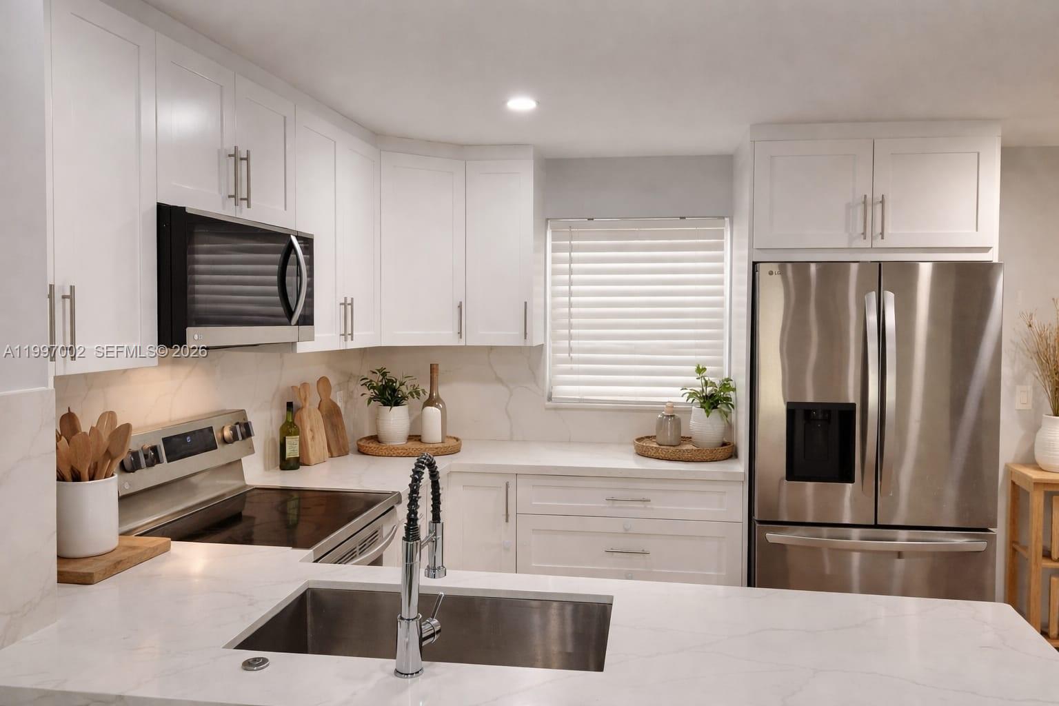 2980 Riverside Drive, Unit 1253 Coral Springs, FL 33065 - Photo 4 of 18 a kitchen with granite countertop a refrigerator and a stove top oven