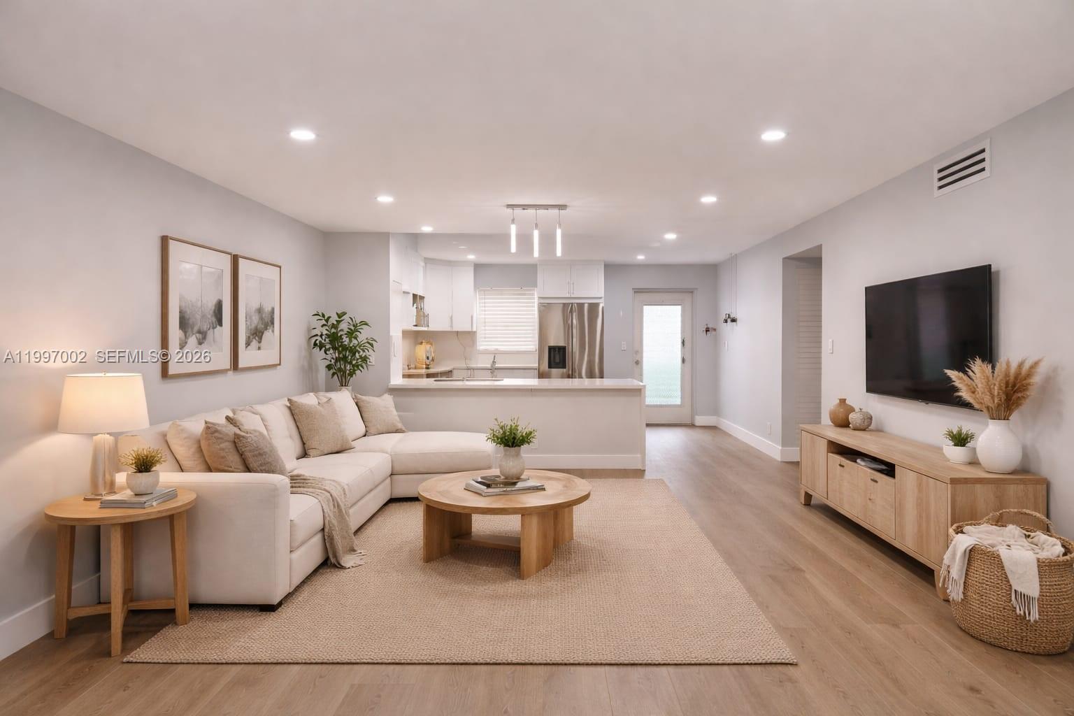 2980 Riverside Drive, Unit 1253 Coral Springs, FL 33065 - Photo 5 of 18 a living room with furniture and a flat screen tv