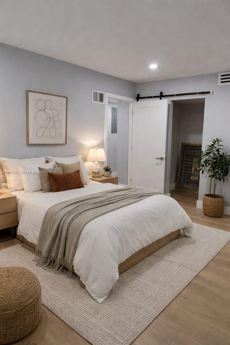 2980 Riverside Drive, Unit 1253 Coral Springs, FL 33065 - Photo 8 of 18 a bedroom with a large bed and a couch