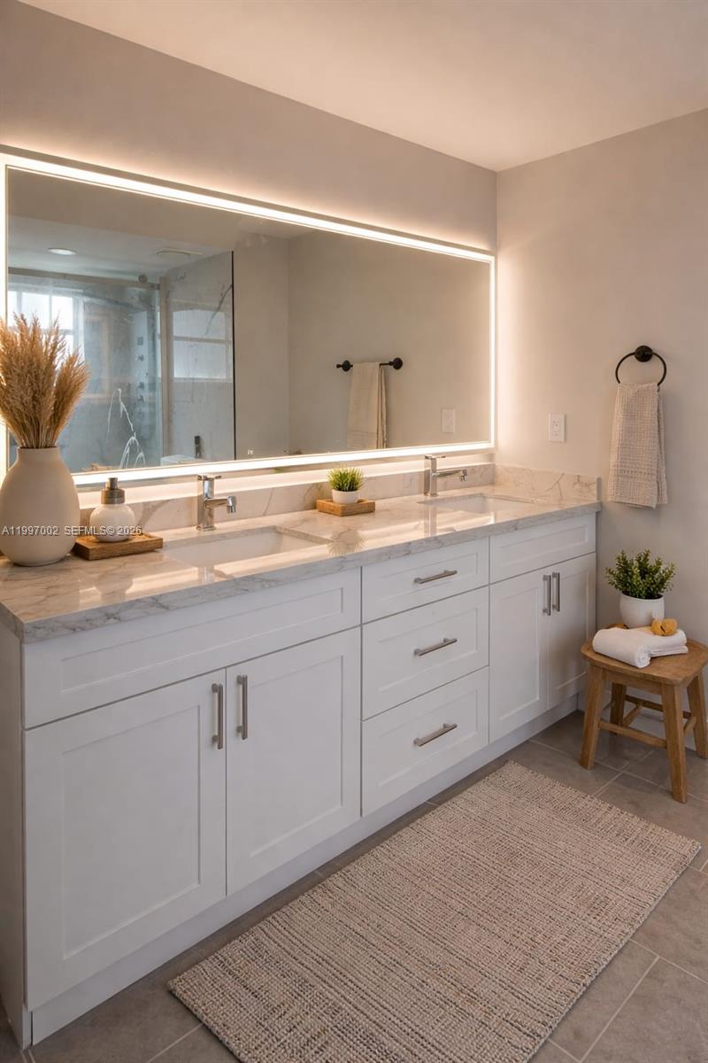 2980 Riverside Drive, Unit 1253 Coral Springs, FL 33065 - Photo 9 of 18 a spacious bathroom with a granite countertop sink and a mirror