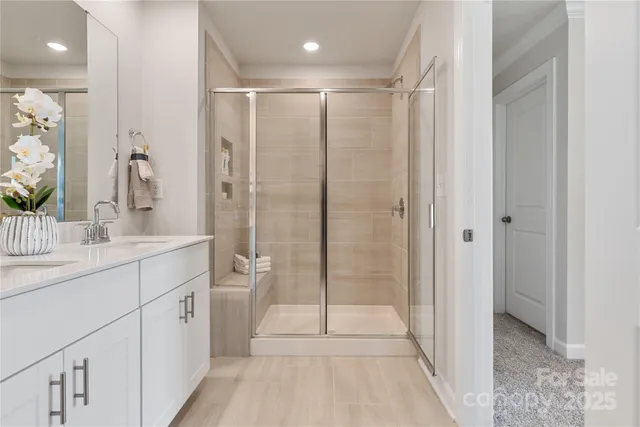 a bathroom with a shower sink and mirror