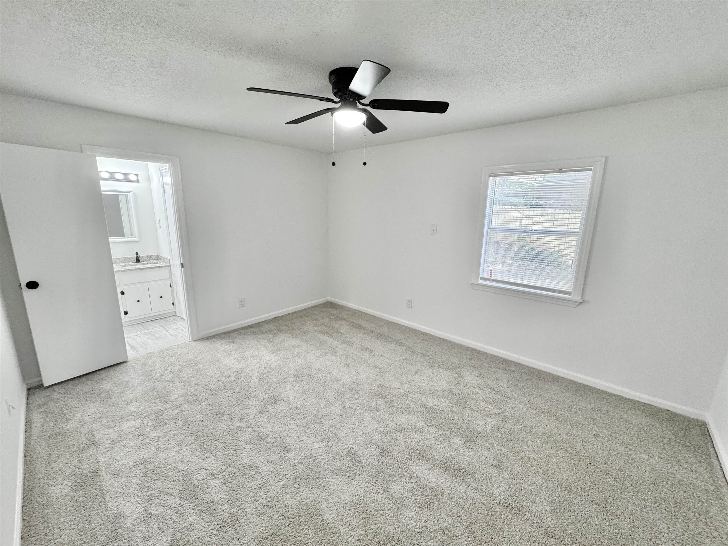 3209 Canyon Road Memphis, TN 38134 - Photo 11 of 30 an empty room with a ceiling fan and window