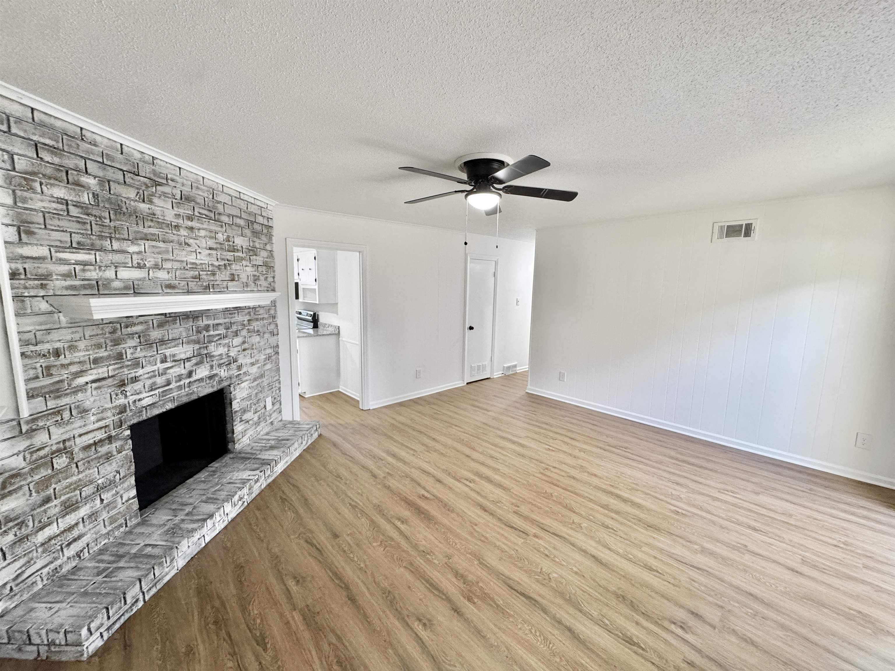 3209 Canyon Road Memphis, TN 38134 - Photo 3 of 30 a view of empty room with wooden floor and fireplace