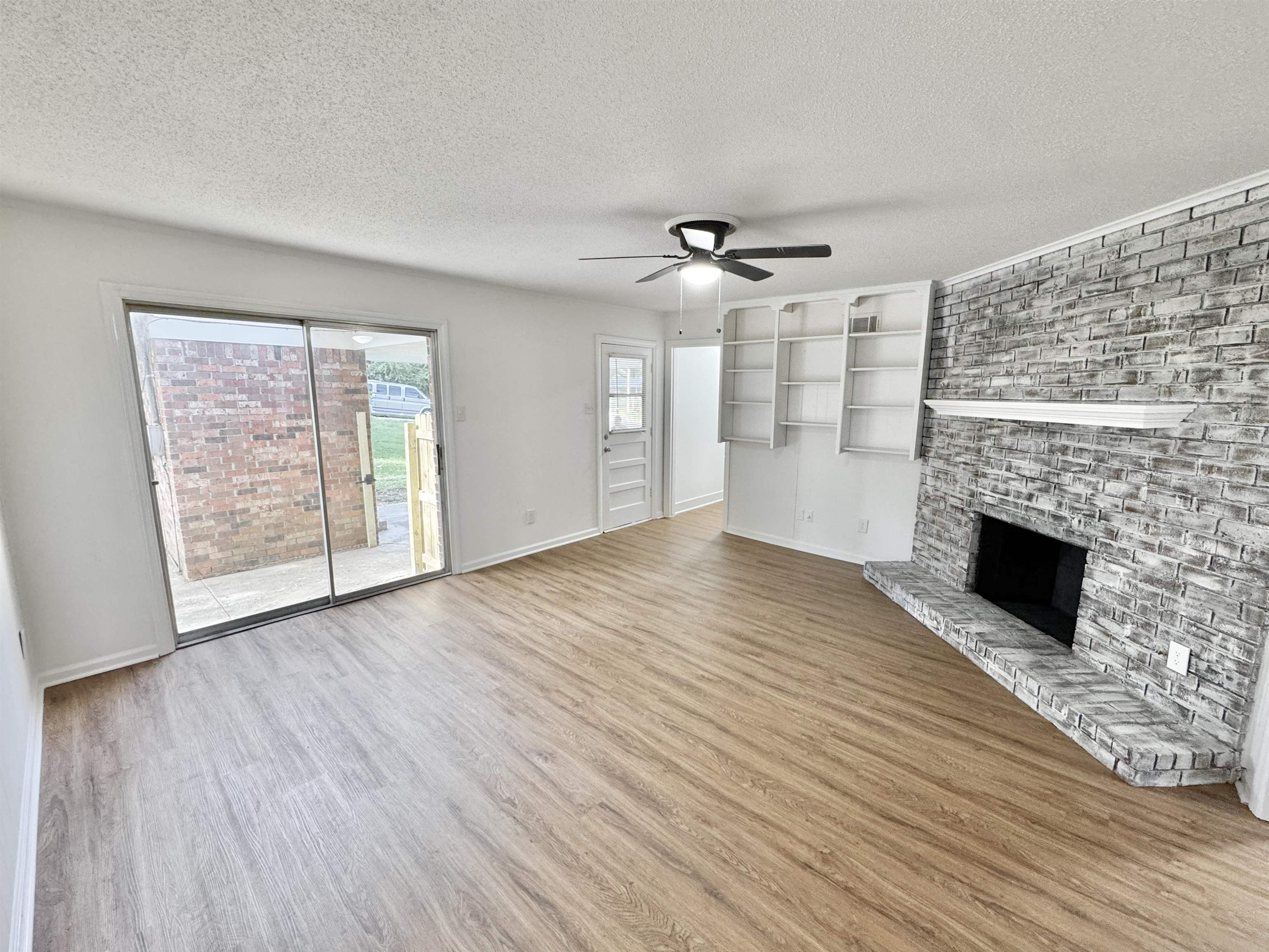 3209 Canyon Road Memphis, TN 38134 - Photo 5 of 30 a view of empty room with wooden floor and fireplace