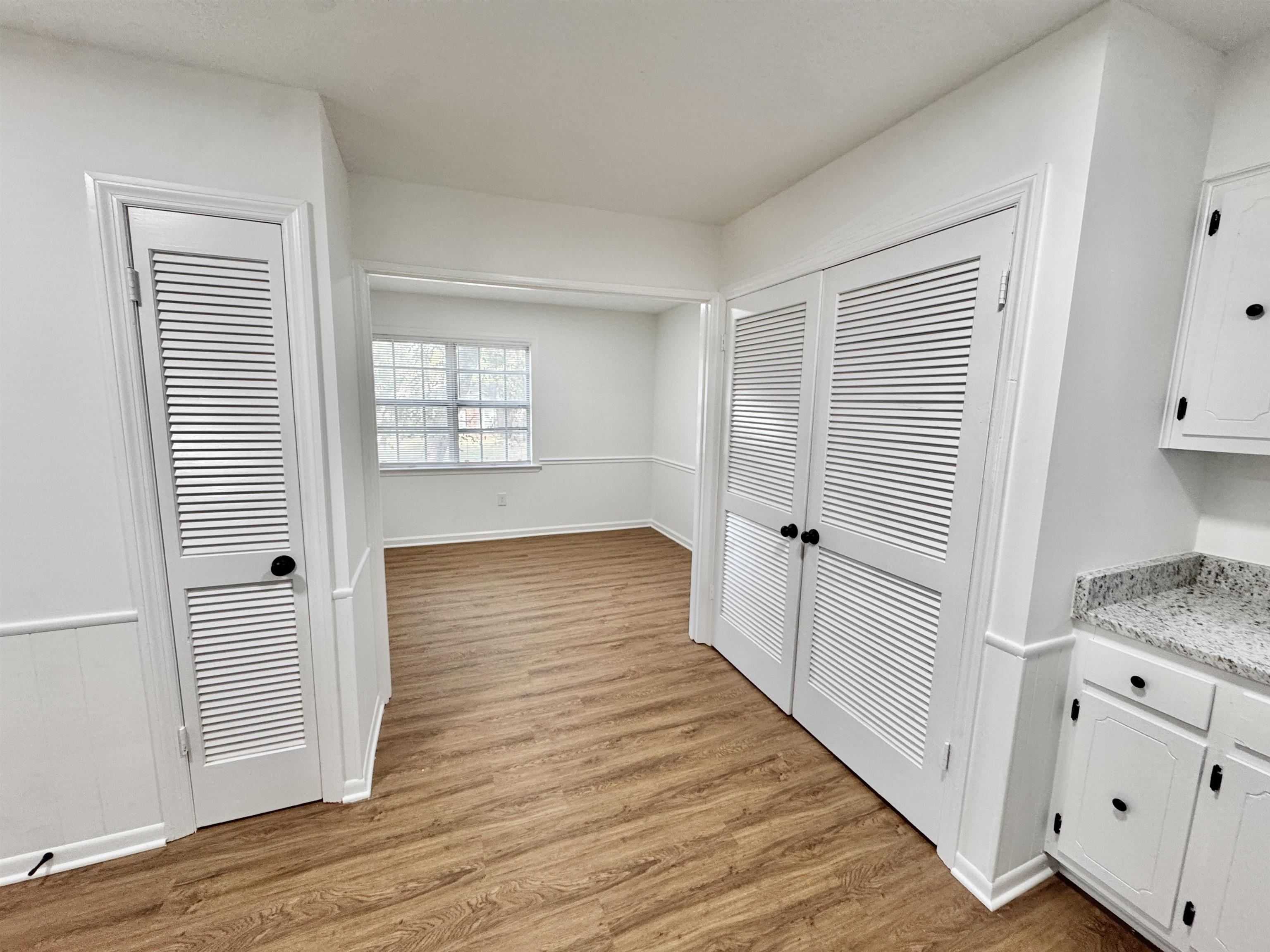 3209 Canyon Road Memphis, TN 38134 - Photo 8 of 30 an empty room with wooden floor and windows