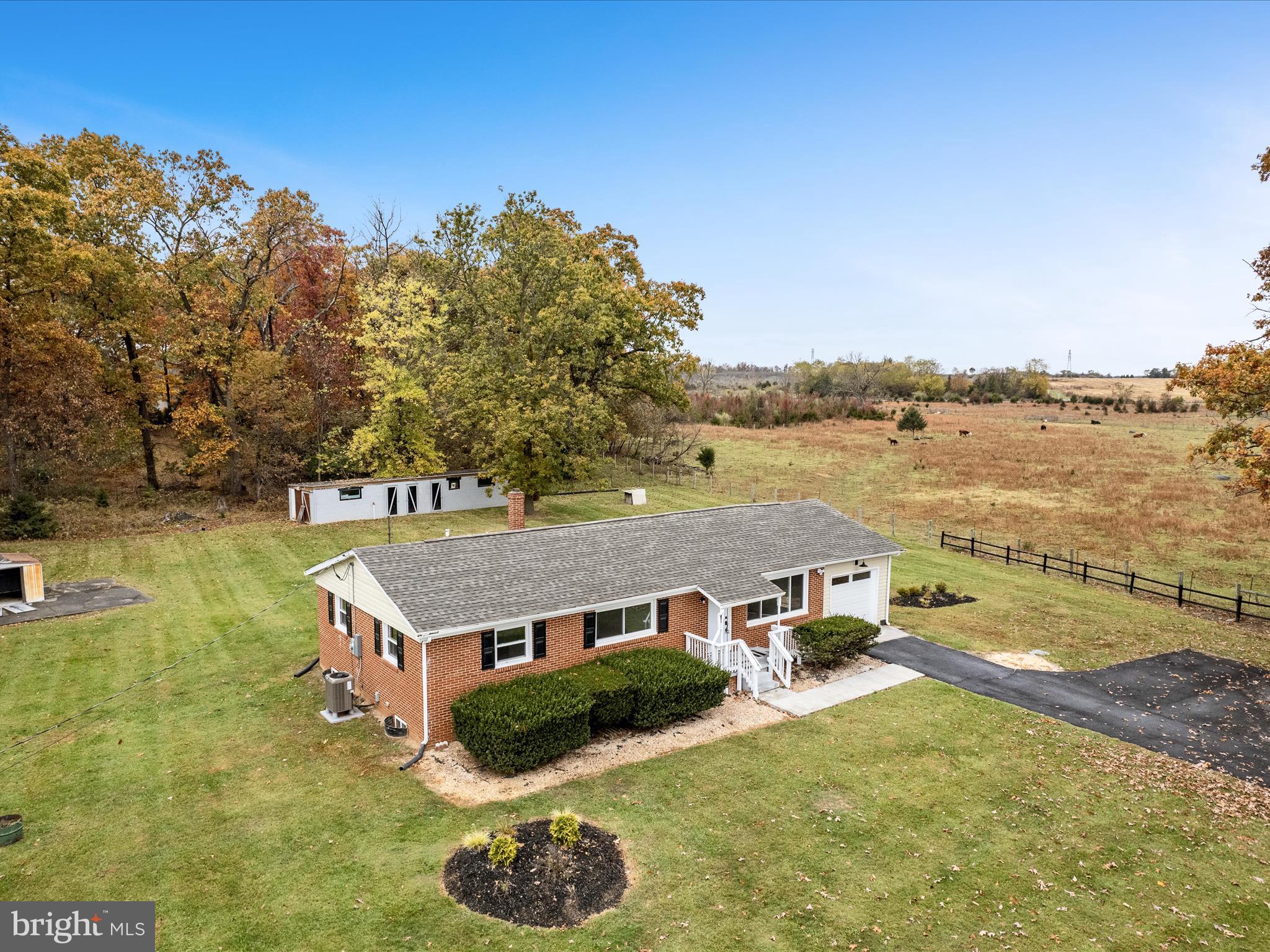 a view of a house with pool and a yard