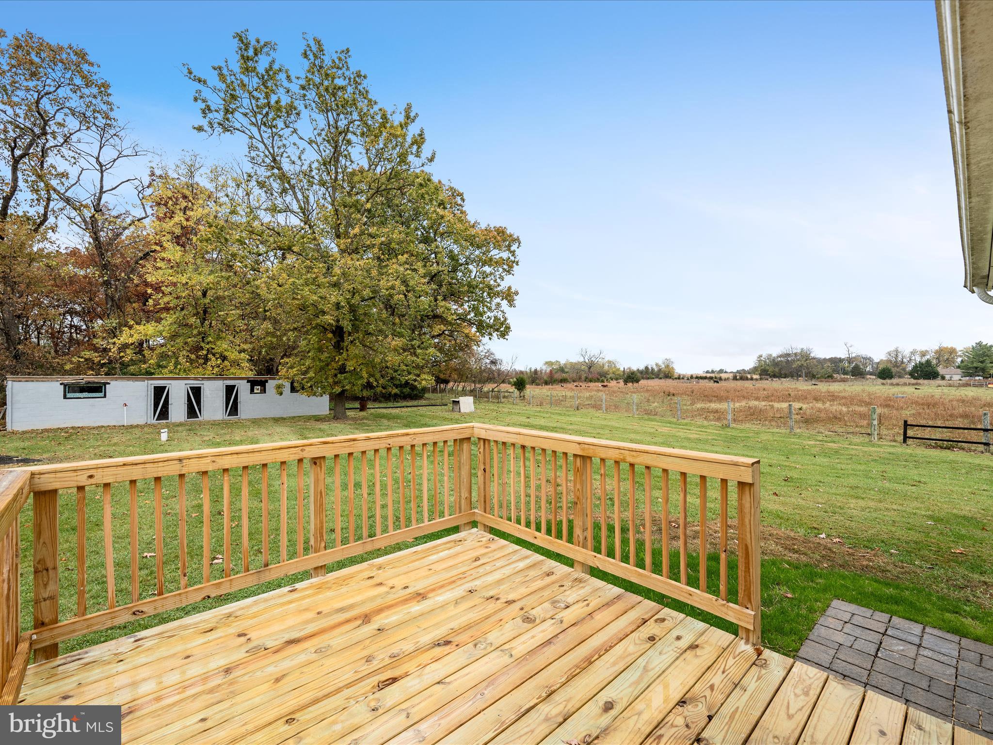 2311 Summit Point Road Summit Point, WV 25446 - Photo 12 of 46 a view of a balcony with wooden floor and fence next to a yard