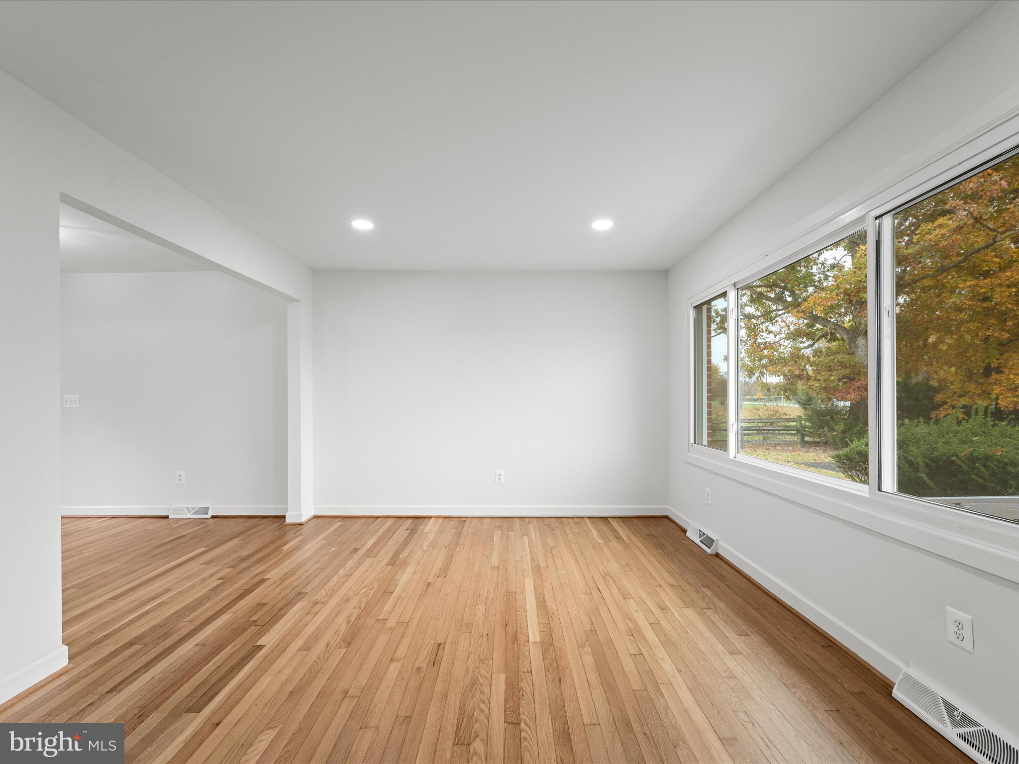 2311 Summit Point Road Summit Point, WV 25446 - Photo 16 of 46 an empty room with wooden floor and windows