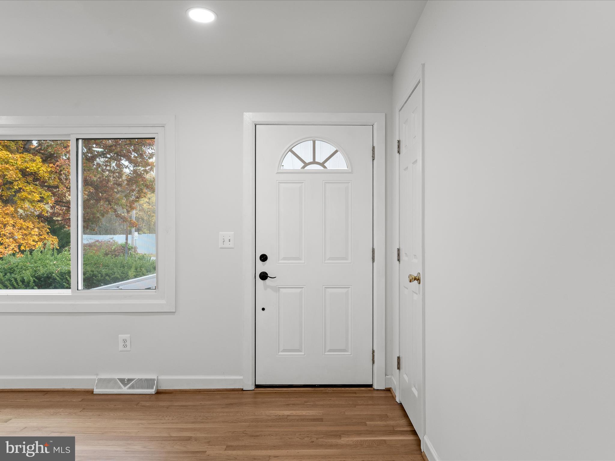 2311 Summit Point Road Summit Point, WV 25446 - Photo 18 of 46 an empty room with wooden floor and windows