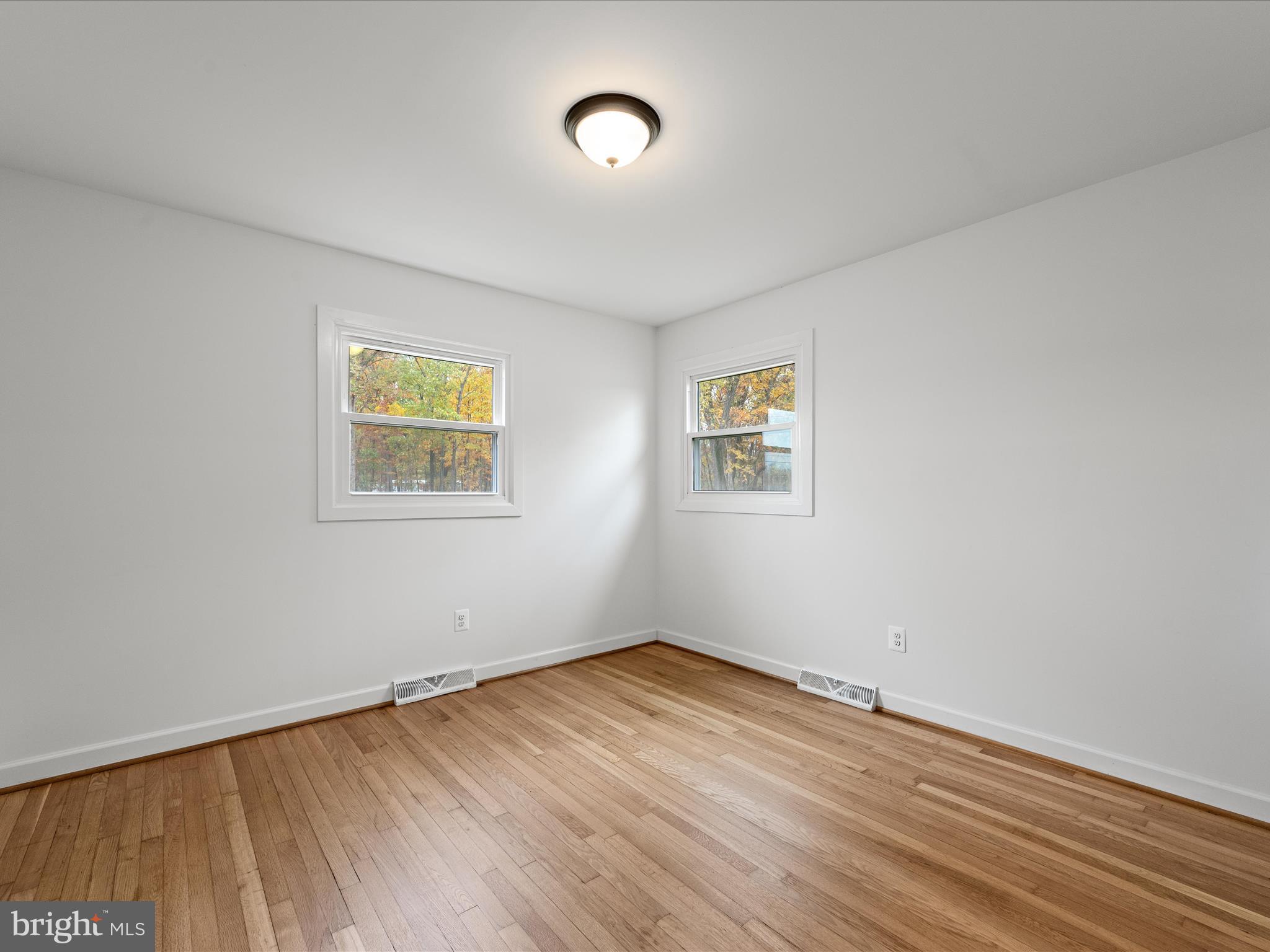 2311 Summit Point Road Summit Point, WV 25446 - Photo 19 of 46 a view of a room with wooden floor and window