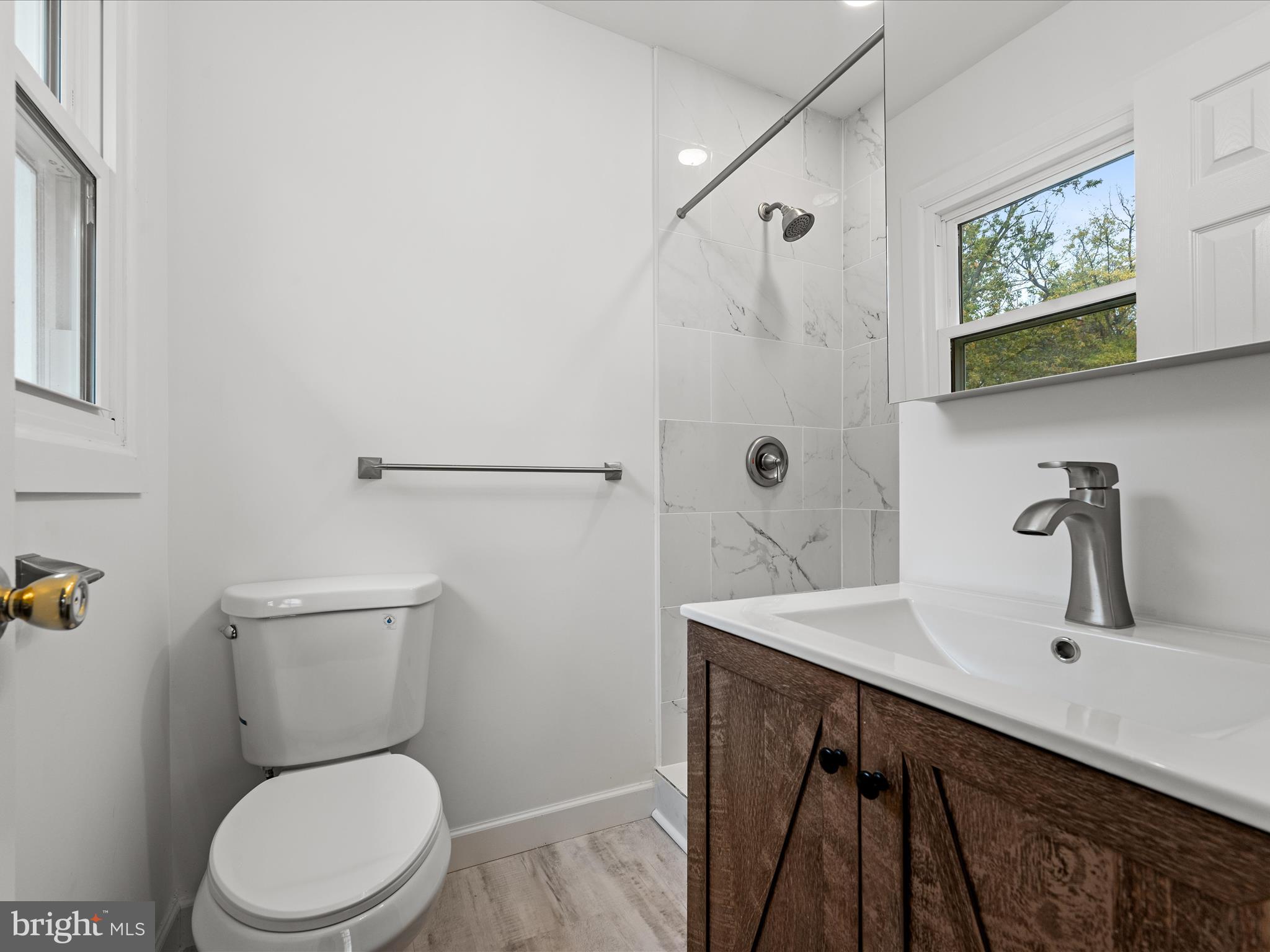 2311 Summit Point Road Summit Point, WV 25446 - Photo 21 of 46 a bathroom with a sink a toilet and shower