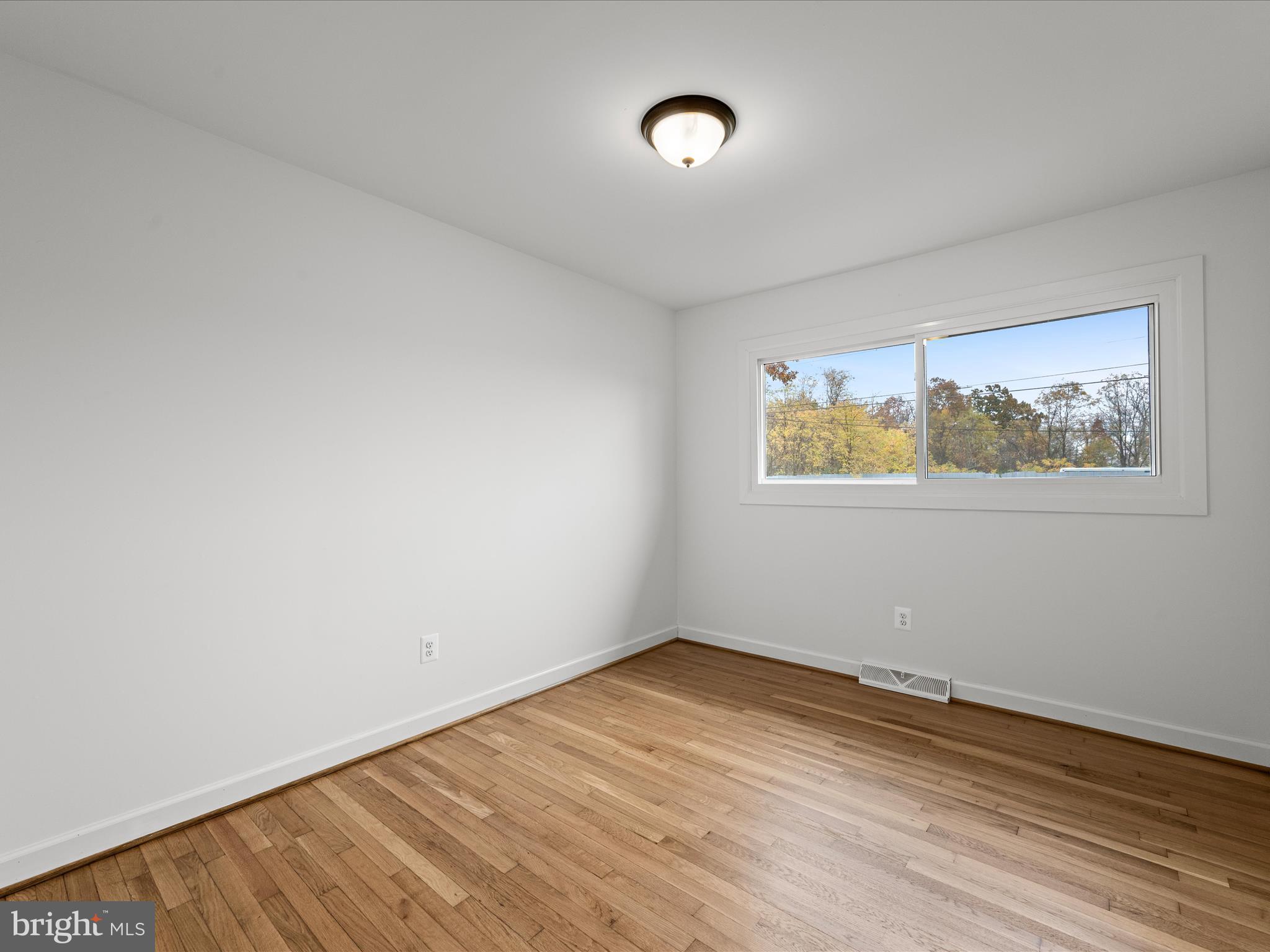 2311 Summit Point Road Summit Point, WV 25446 - Photo 23 of 46 an empty room with wooden floor and window