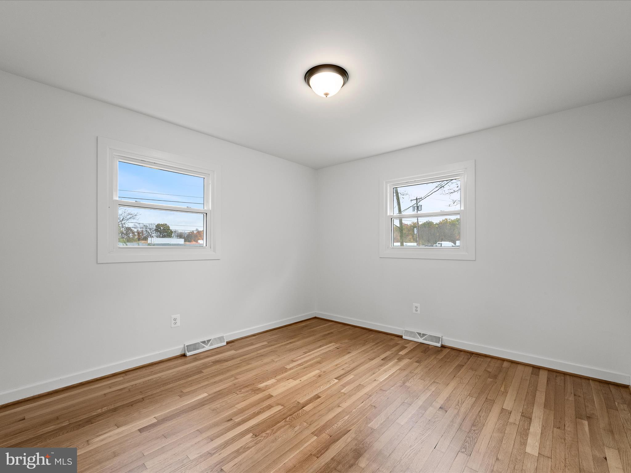 2311 Summit Point Road Summit Point, WV 25446 - Photo 26 of 46 a view of an empty room with wooden floor and a window