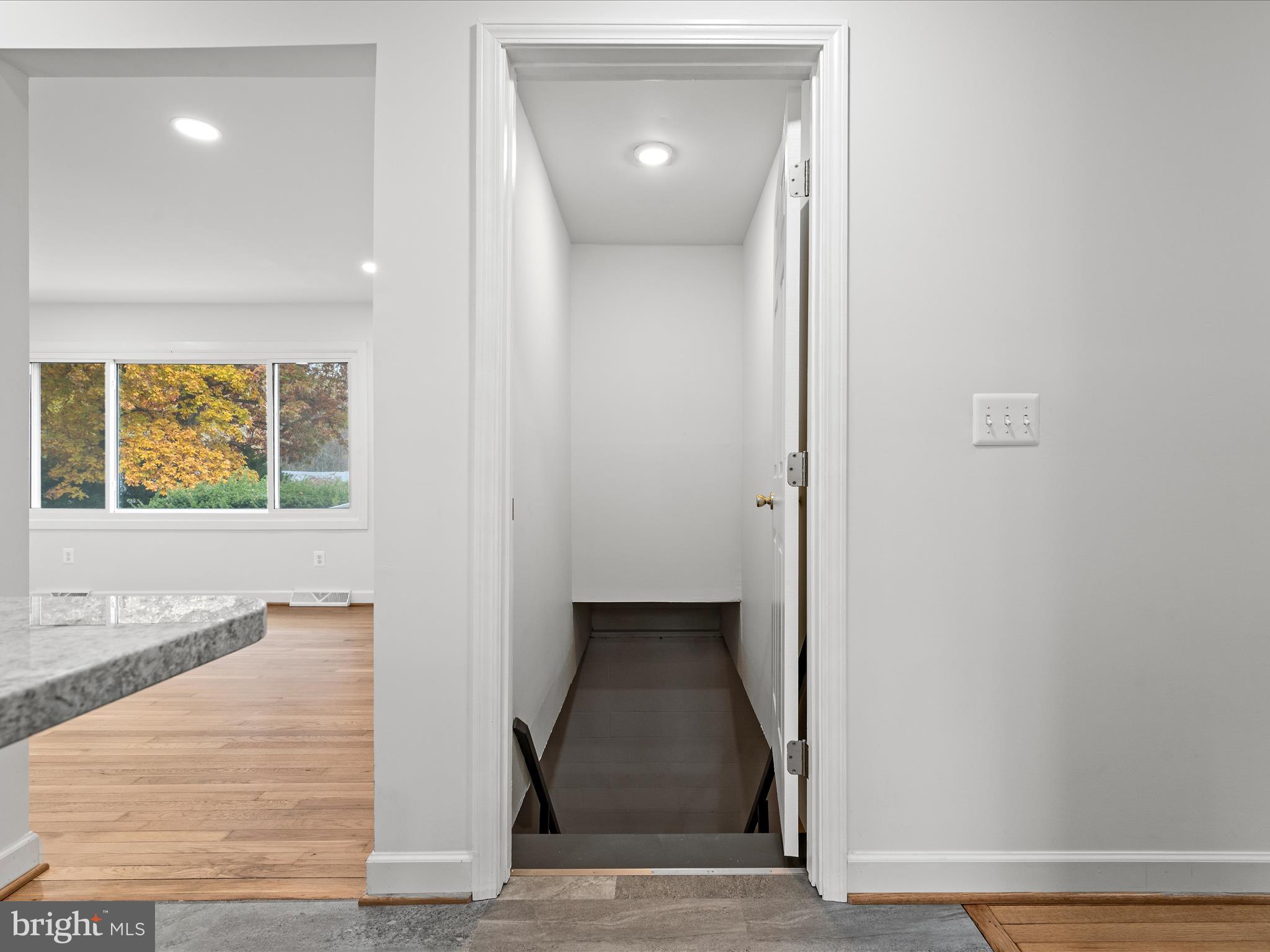 2311 Summit Point Road Summit Point, WV 25446 - Photo 28 of 46 a view of a hallway with wooden floor and a living room