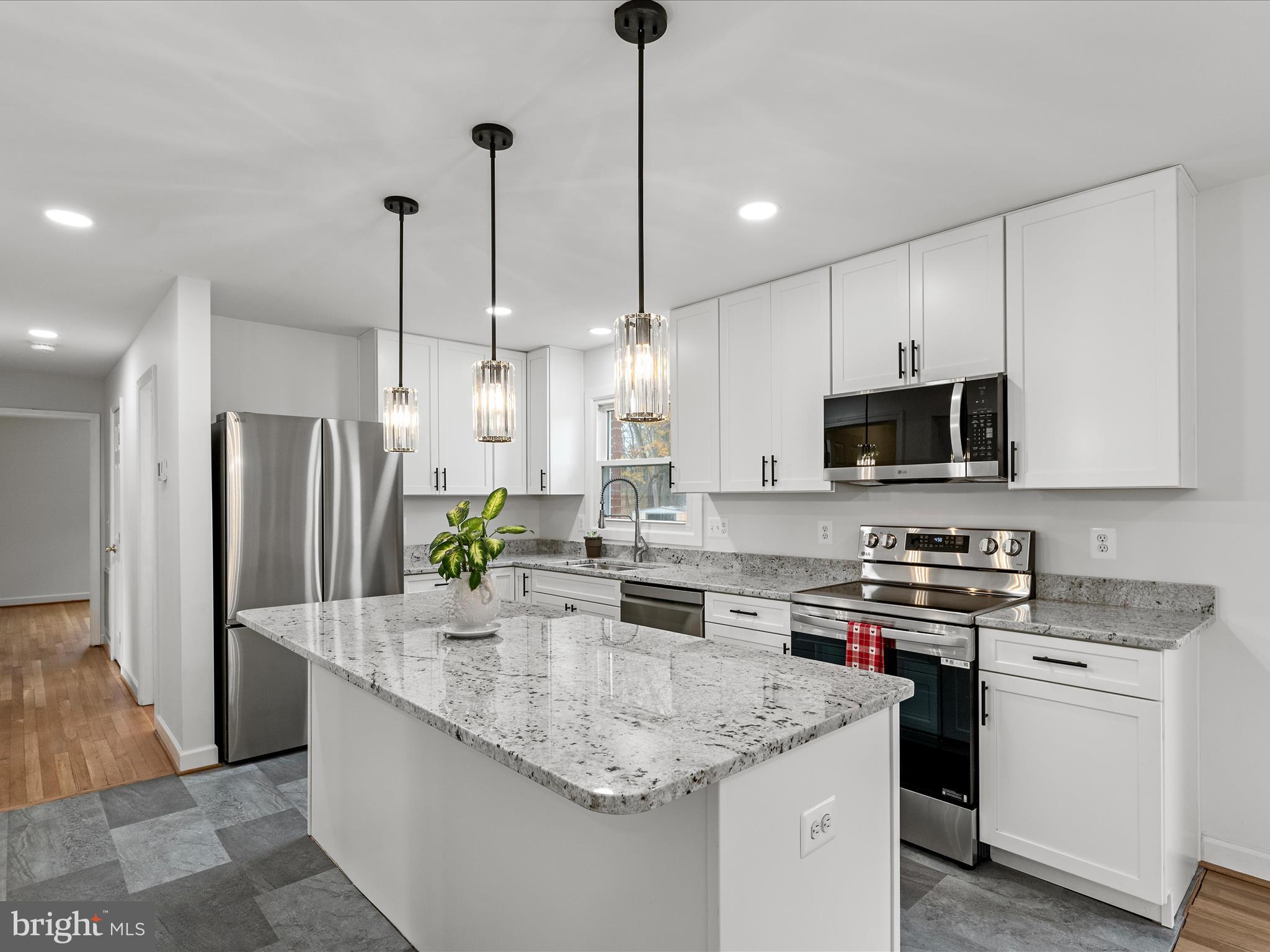 2311 Summit Point Road Summit Point, WV 25446 - Photo 5 of 46 a kitchen with stainless steel appliances granite countertop a sink a stove a refrigerator and cabinets