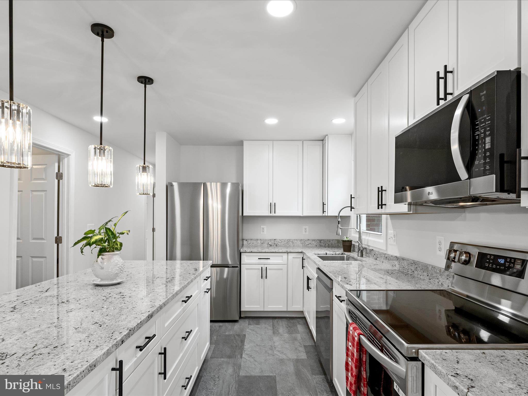 2311 Summit Point Road Summit Point, WV 25446 - Photo 6 of 46 a kitchen with granite countertop a sink stainless steel appliances and cabinets