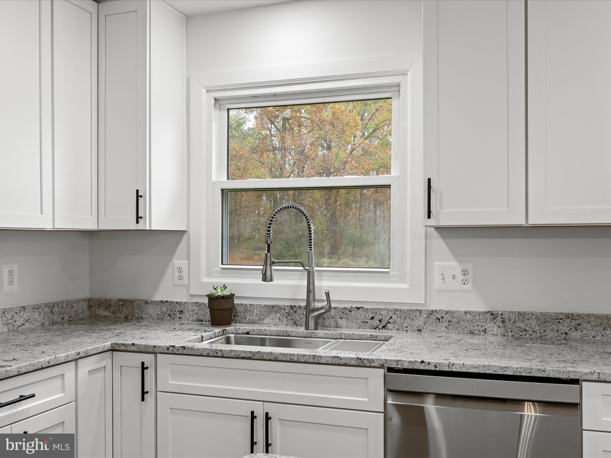 2311 Summit Point Road Summit Point, WV 25446 - Photo 7 of 46 a kitchen with granite countertop white cabinets and a window