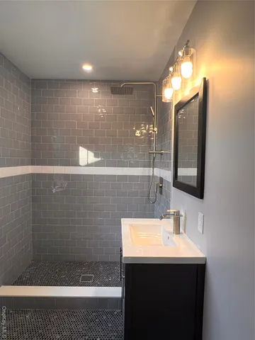 a bathroom with a sink a mirror and a shower