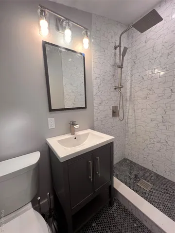 a bathroom with a sink toilet and shower