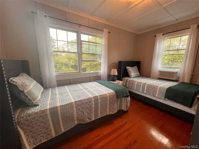 a bedroom with two beds and a couch