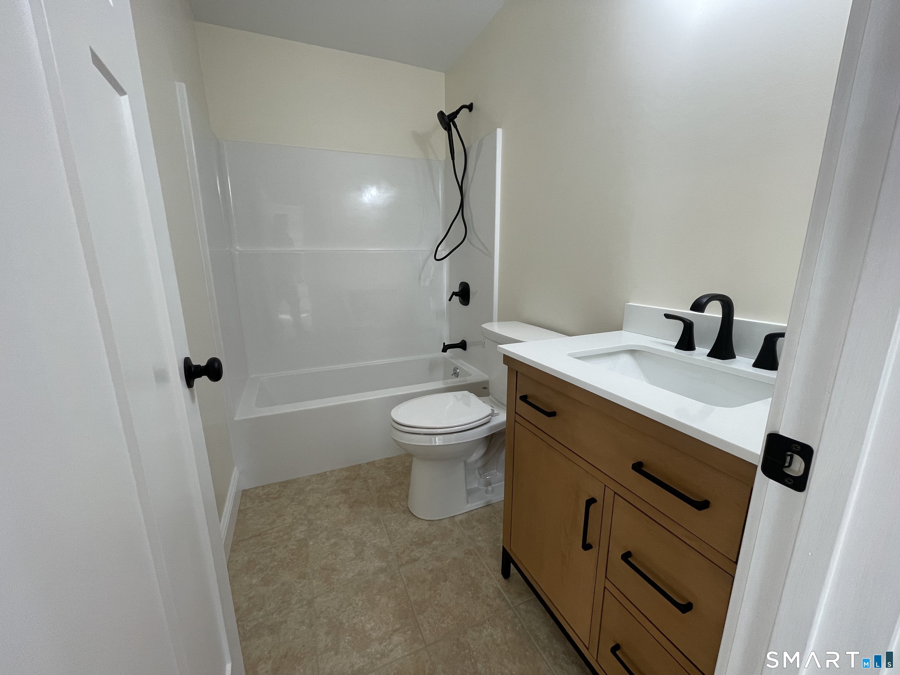 76 Wauregan Road Canterbury, CT 06331 - Photo 12 of 26 a bathroom with a sink a toilet and shower
