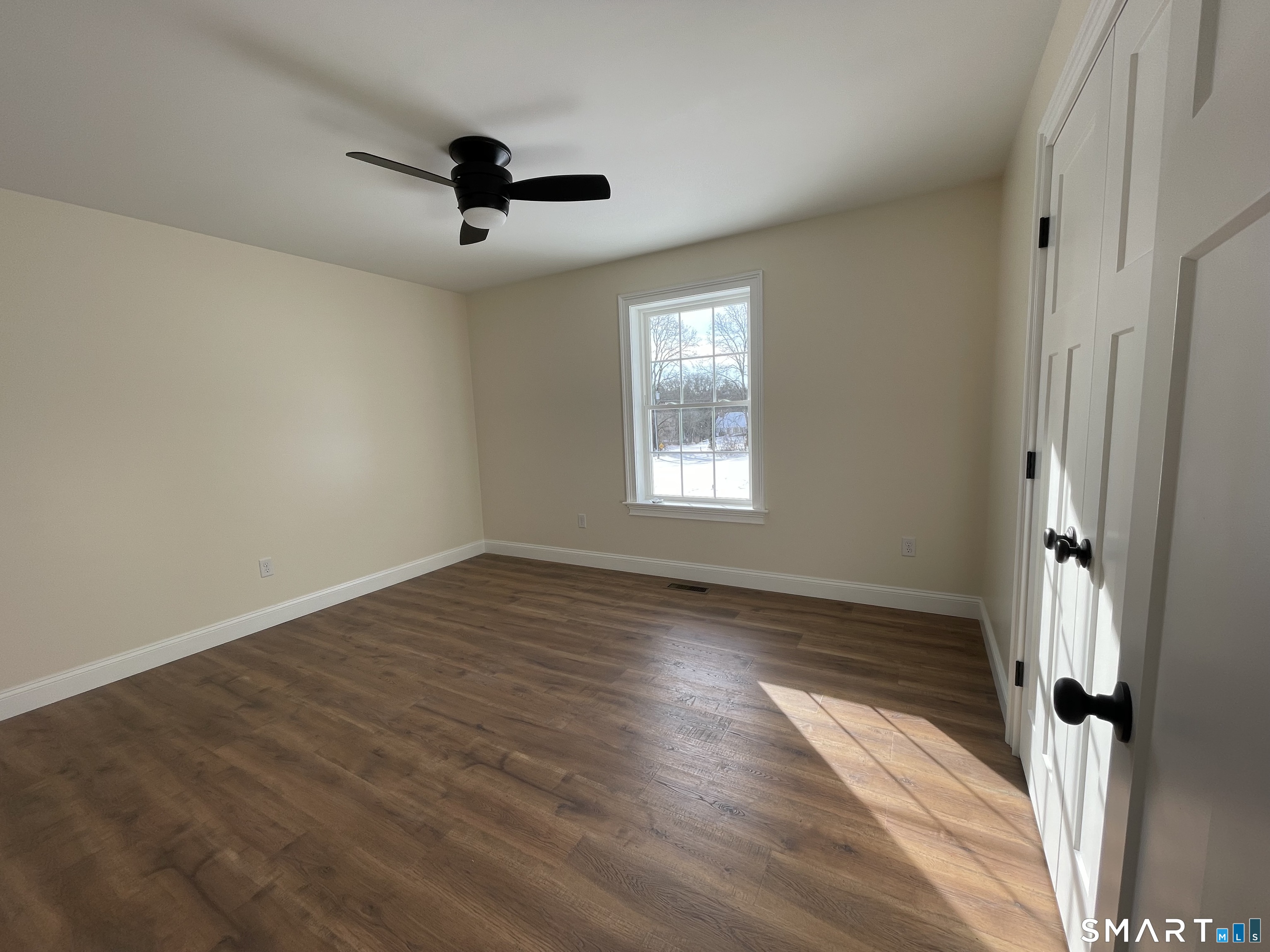 76 Wauregan Road Canterbury, CT 06331 - Photo 13 of 26 wooden floor in an empty room with a window