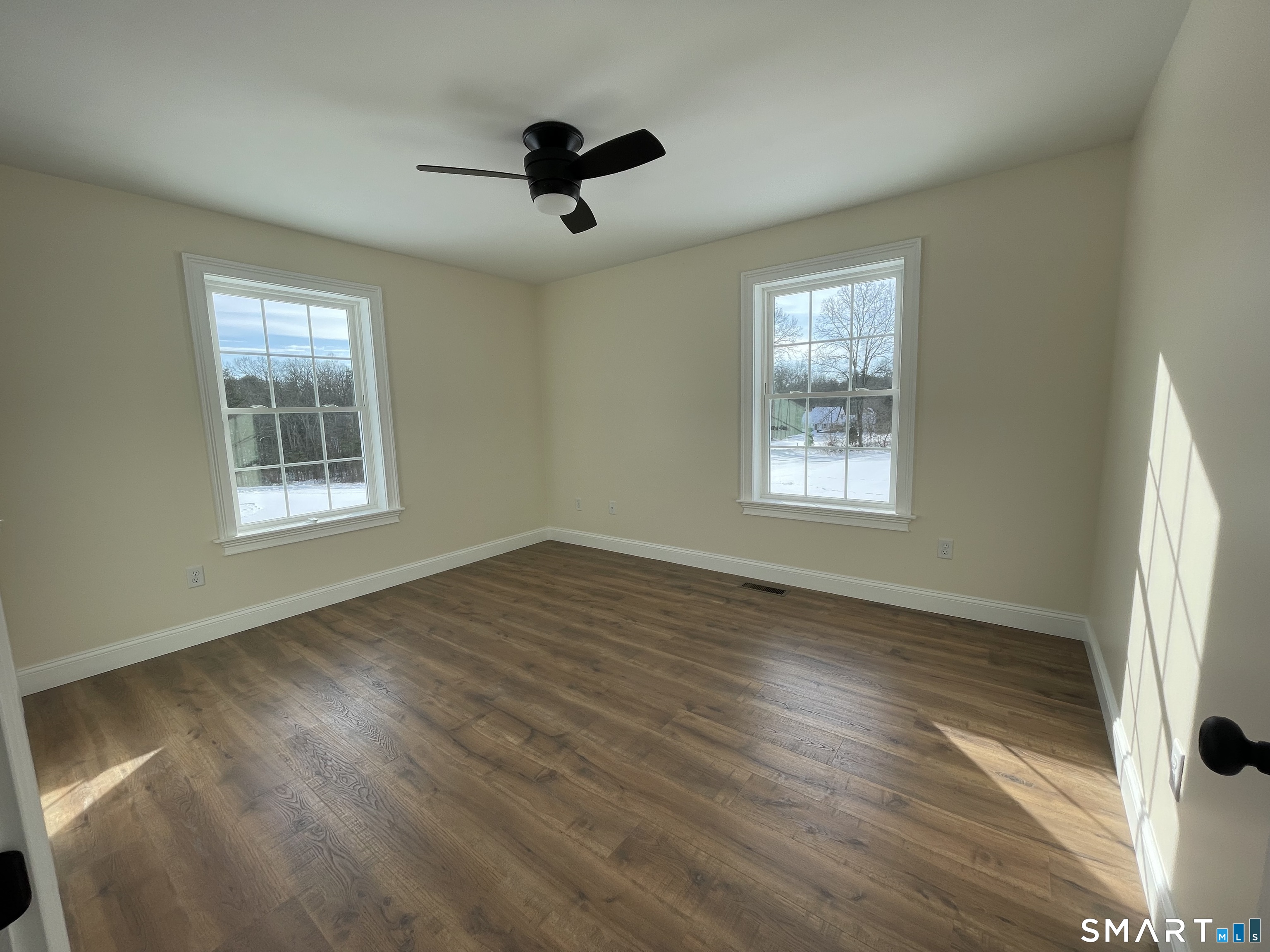76 Wauregan Road Canterbury, CT 06331 - Photo 14 of 26 a view of an empty room with wooden floor and a window