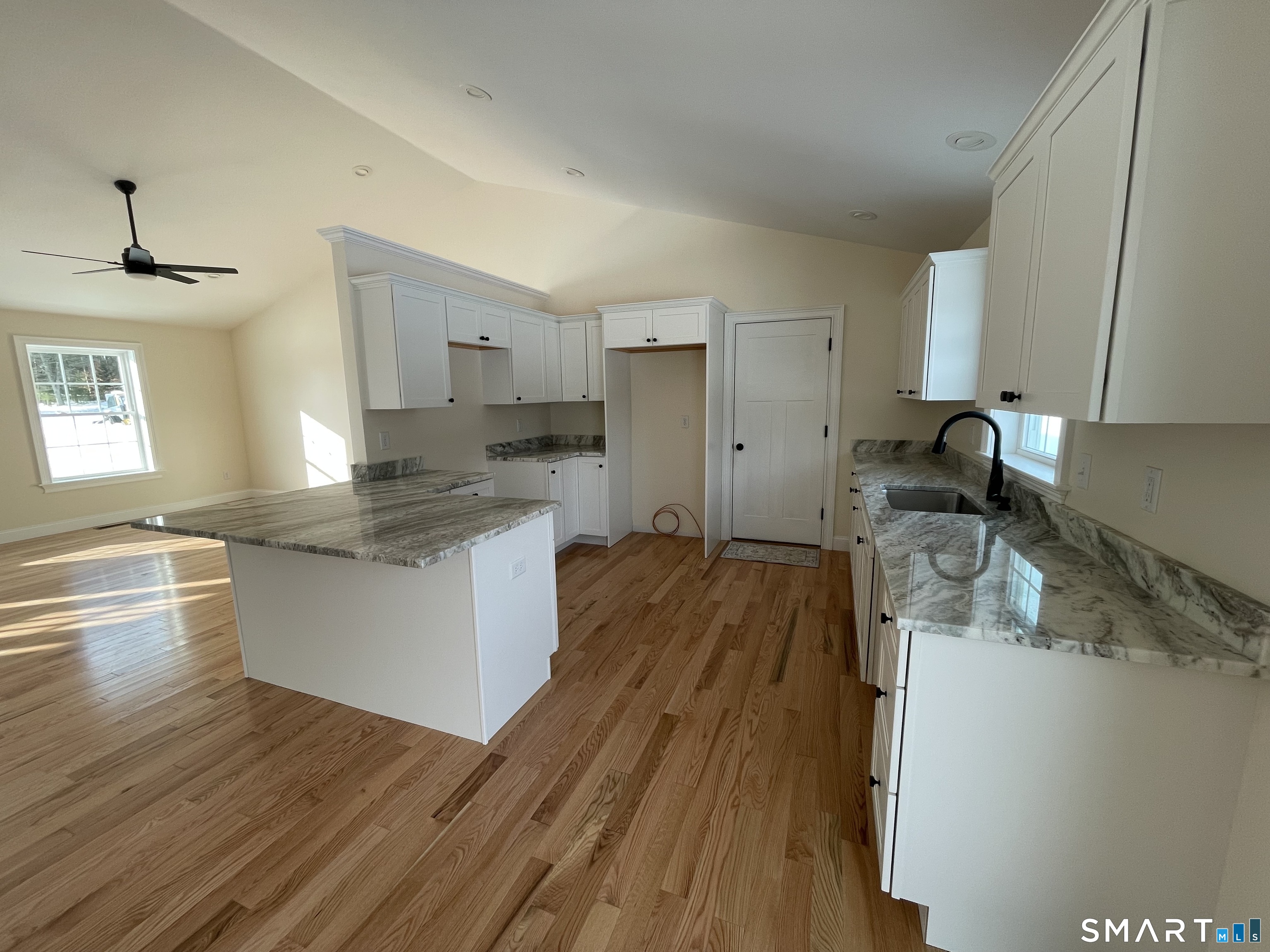 76 Wauregan Road Canterbury, CT 06331 - Photo 10 of 26 a kitchen with wooden floors and white appliances