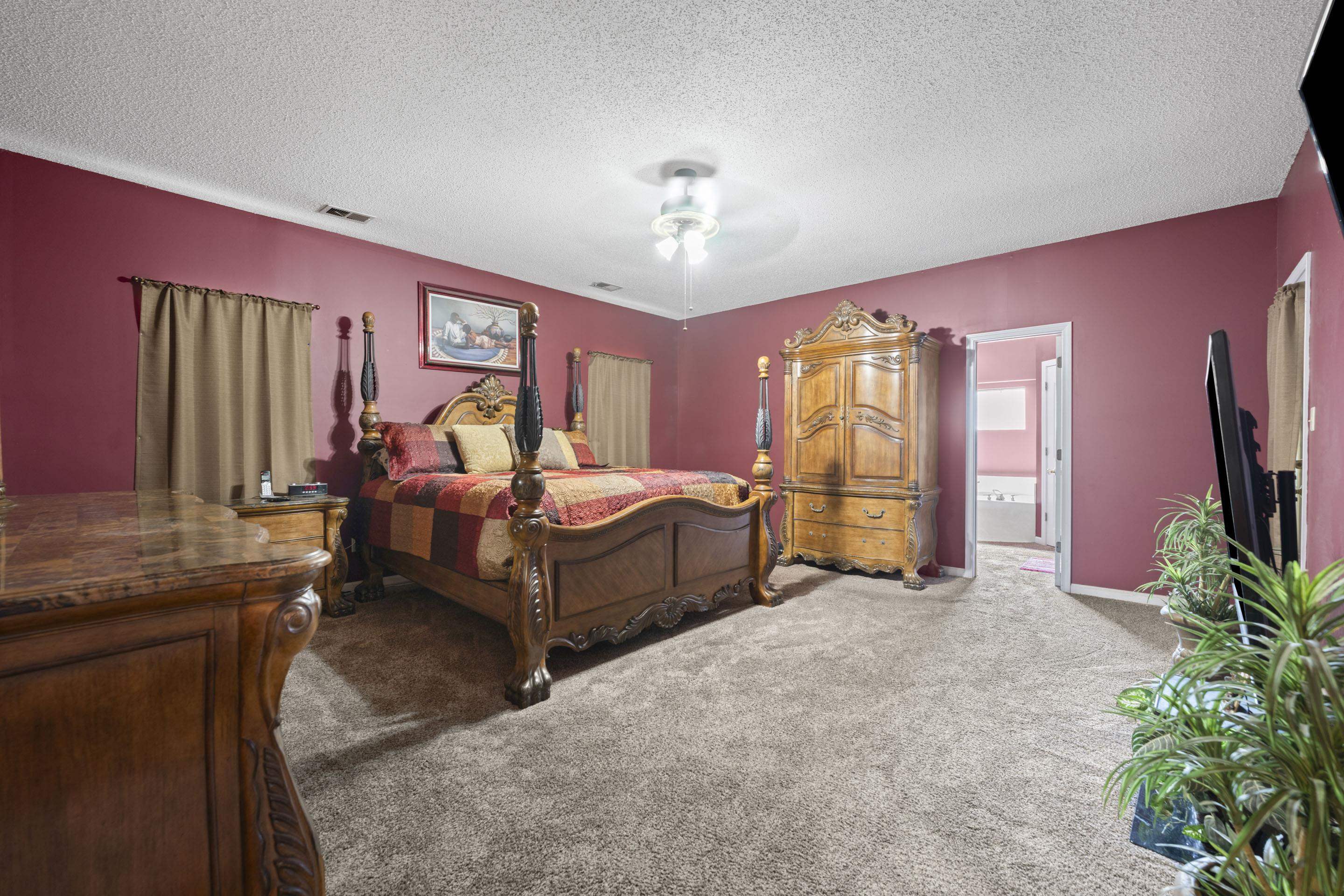 7265 Ward Road Millington, TN 38053 - Photo 12 of 29 Carpeted bedroom with a textured ceiling, a ceiling fan, and ensuite bath