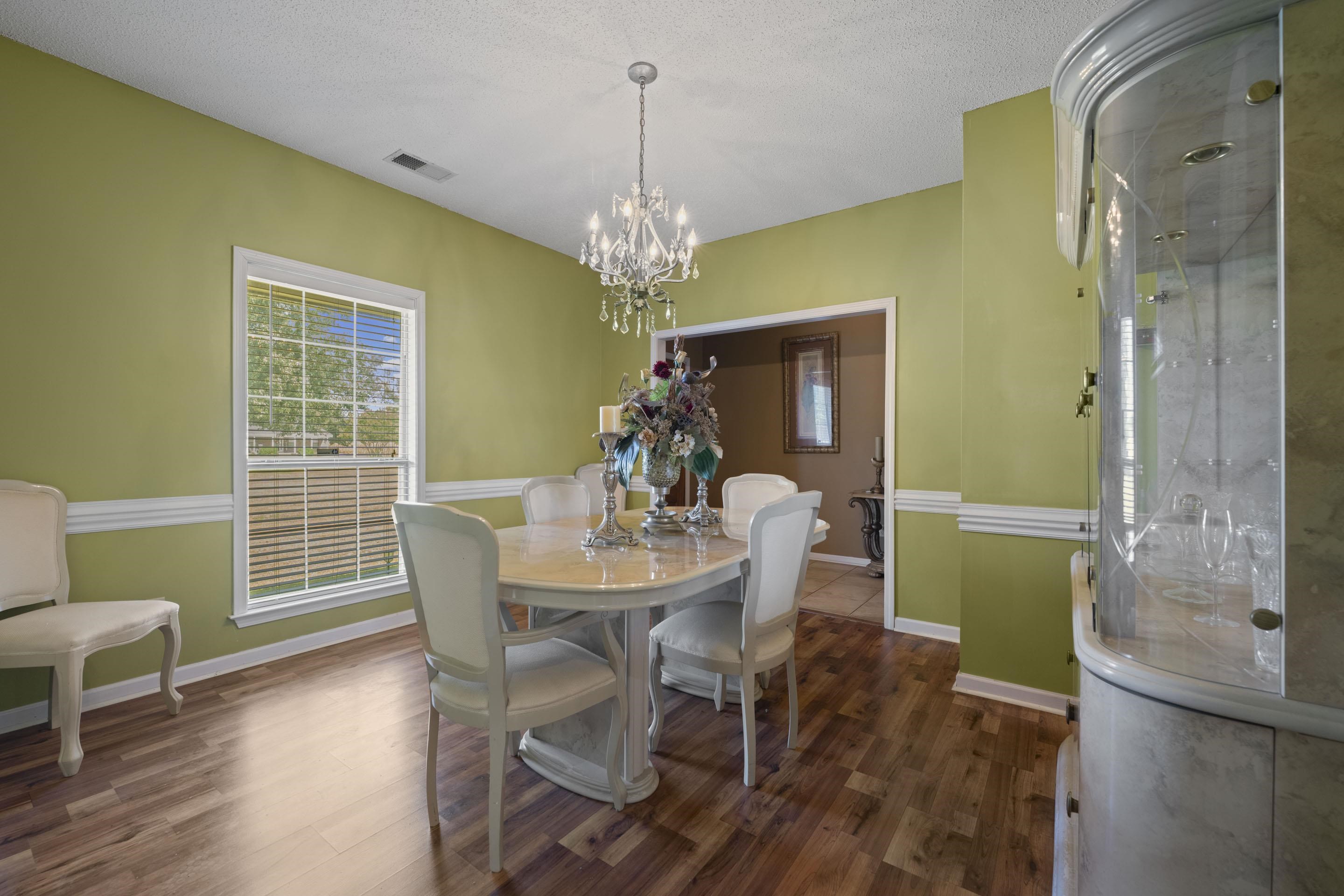 7265 Ward Road Millington, TN 38053 - Photo 7 of 29 Dining area with dark wood-style flooring, a chandelier, and a textured ceiling