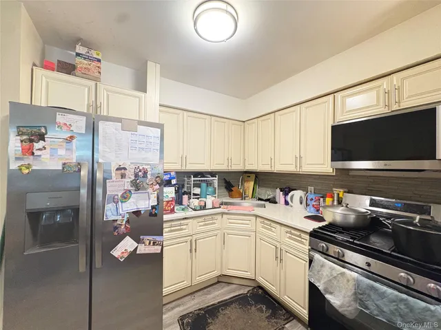 a kitchen with a sink a stove and cabinets