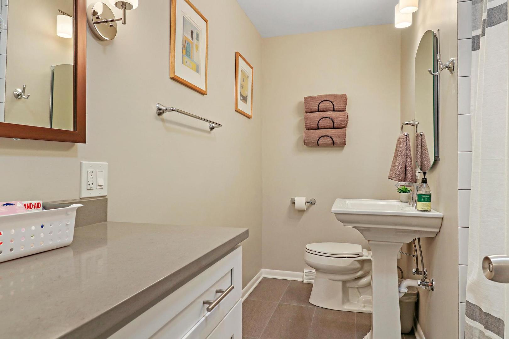 2532 North Jackson Street Waukegan, IL 60087 - Photo 13 of 29 a bathroom with a sink toilet and a mirror