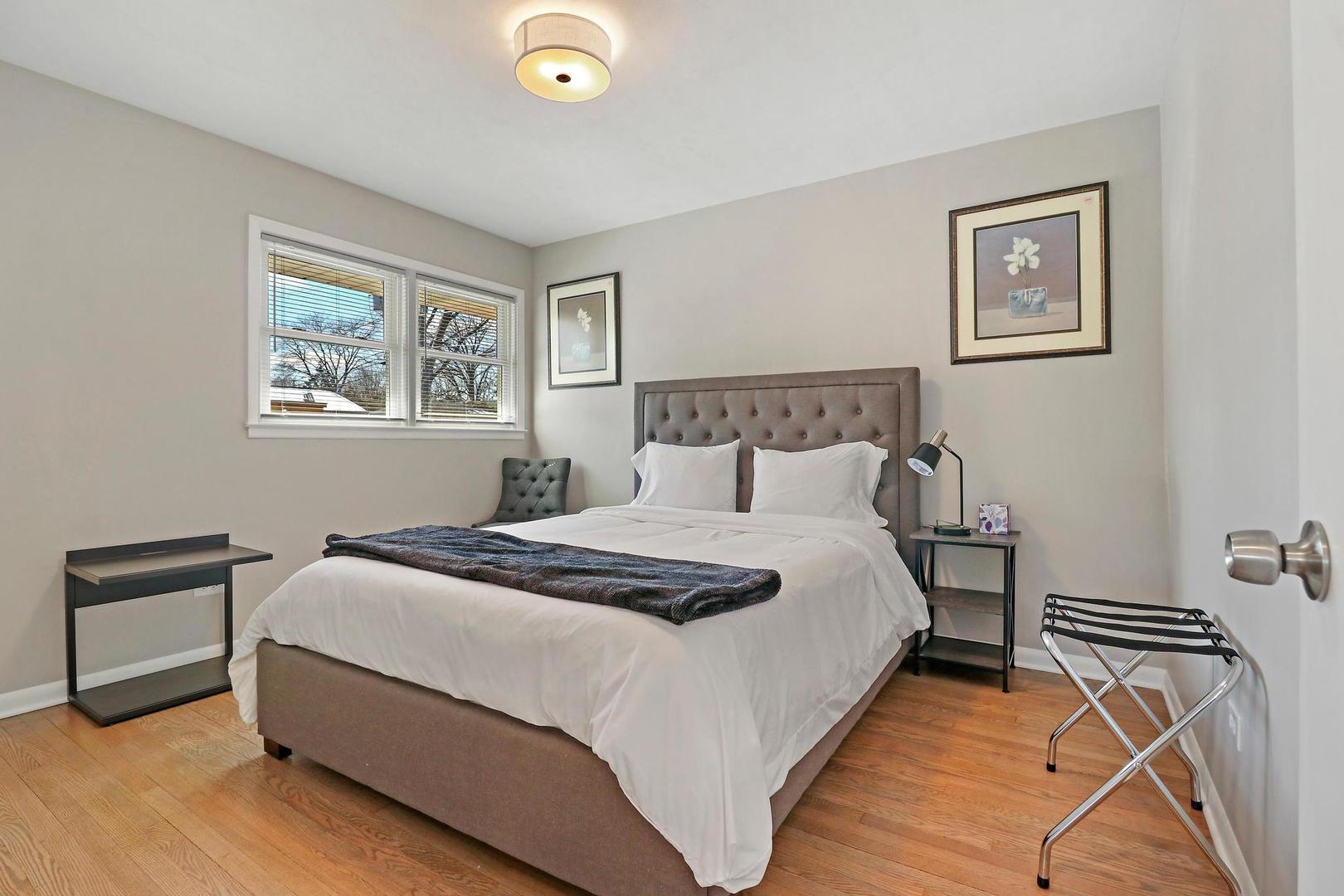 2532 North Jackson Street Waukegan, IL 60087 - Photo 14 of 29 a bedroom with bed and paintings on the wall