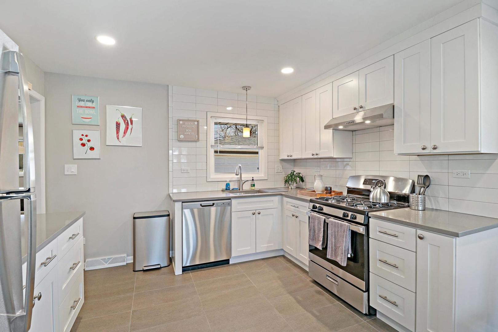 2532 North Jackson Street Waukegan, IL 60087 - Photo 16 of 29 a kitchen with stainless steel appliances granite countertop a stove and a sink