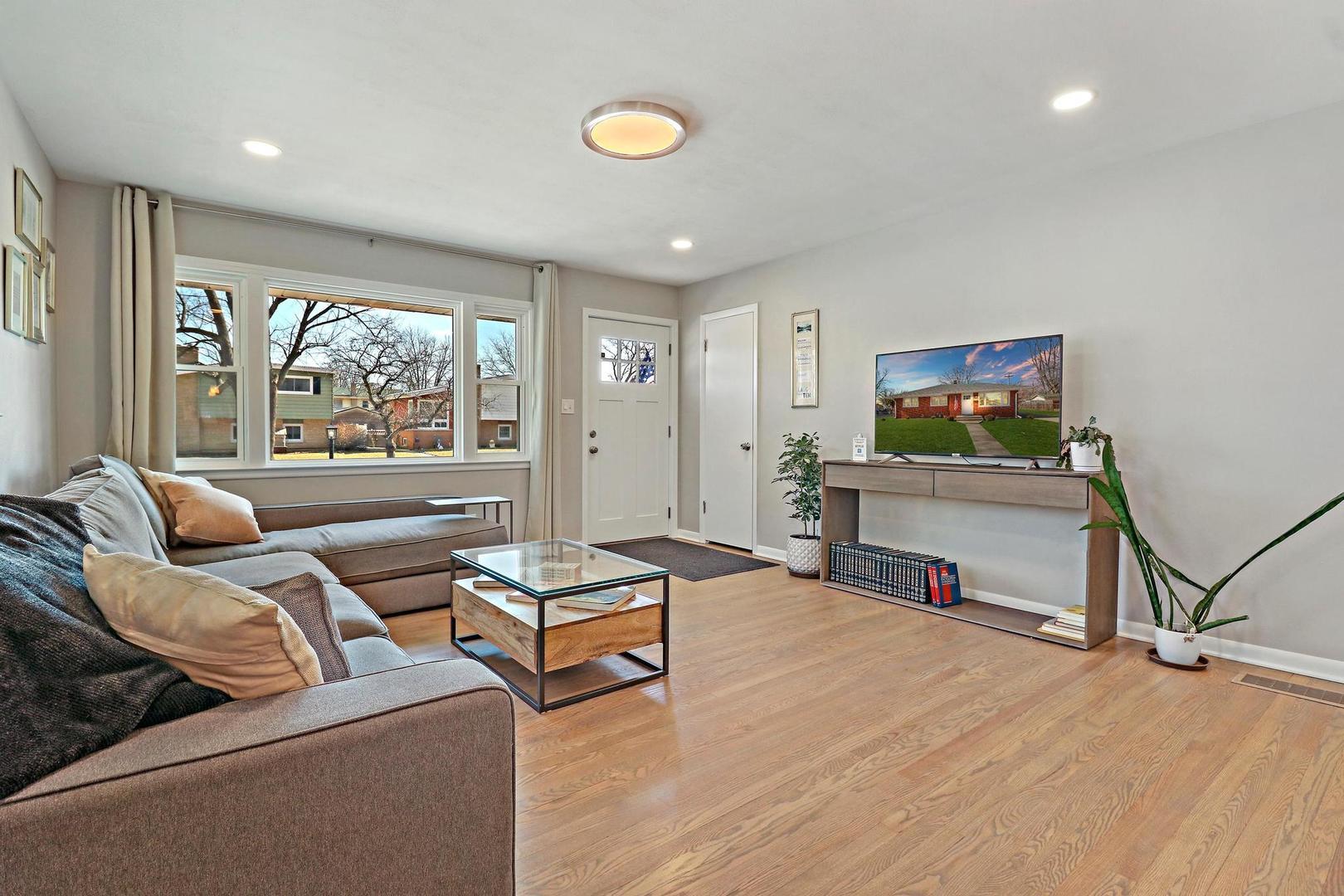 2532 North Jackson Street Waukegan, IL 60087 - Photo 8 of 29 a living room with furniture a flat screen tv and a large window