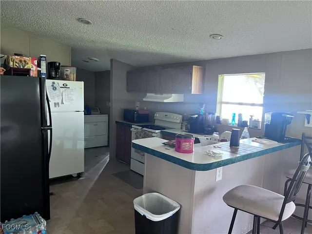 a kitchen with a table and chairs