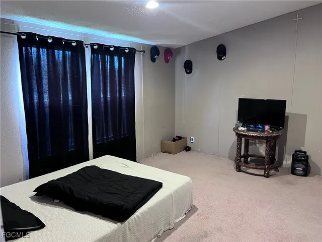 a bedroom with a bed and a television