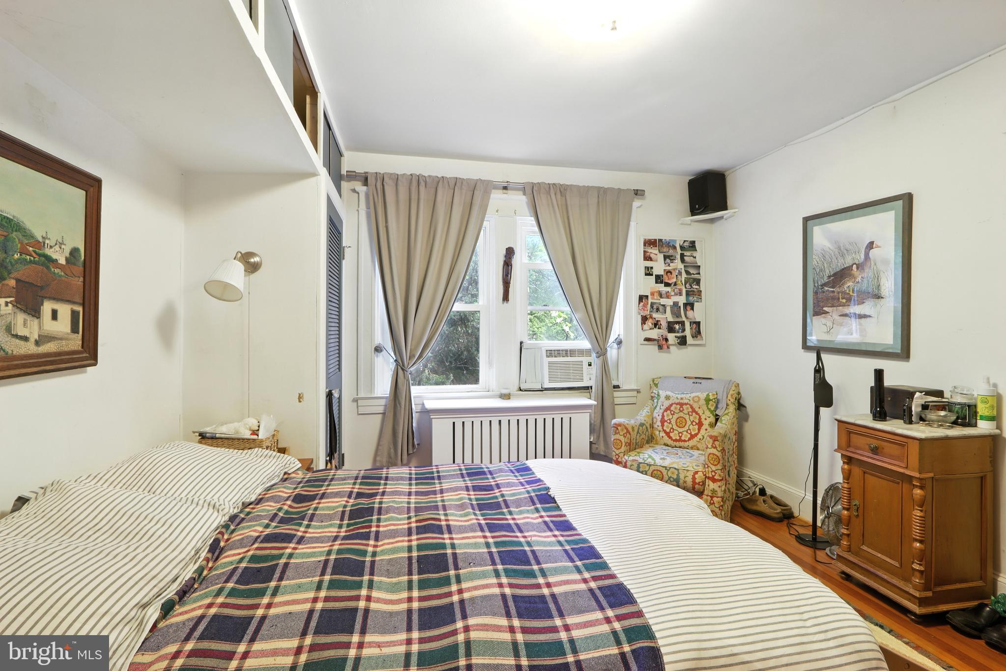 5721 Ridgedale Road Baltimore, MD 21209 - Photo 28 of 54 a bedroom with a bed and wooden floor