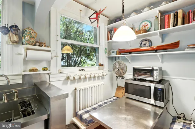 a kitchen with stainless steel appliances a sink stove and cabinets