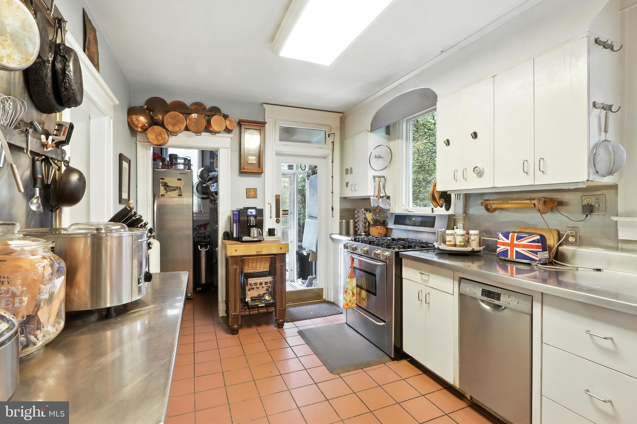 5721 Ridgedale Road Baltimore, MD 21209 - Photo 32 of 54 a kitchen with stainless steel appliances a sink stove and cabinets