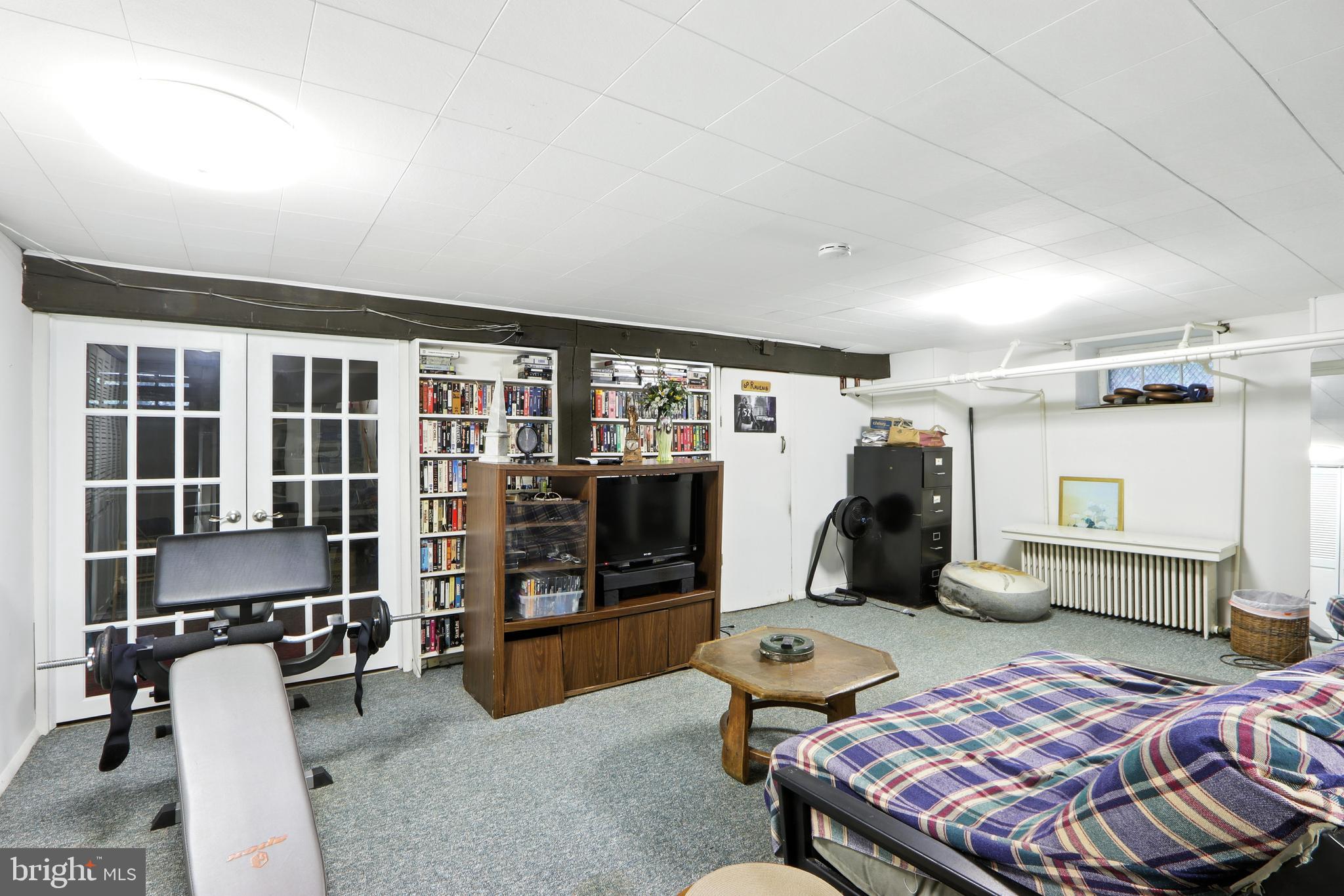5721 Ridgedale Road Baltimore, MD 21209 - Photo 37 of 54 a bedroom with furniture and a wooden floor