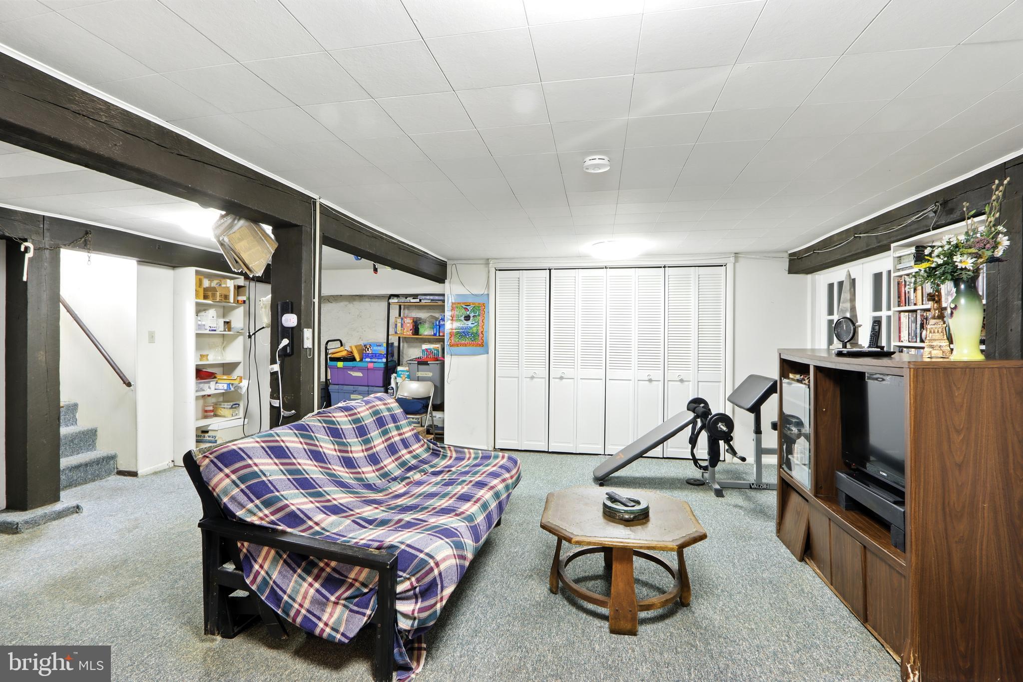 5721 Ridgedale Road Baltimore, MD 21209 - Photo 38 of 54 a living room with furniture a flat screen tv and a table