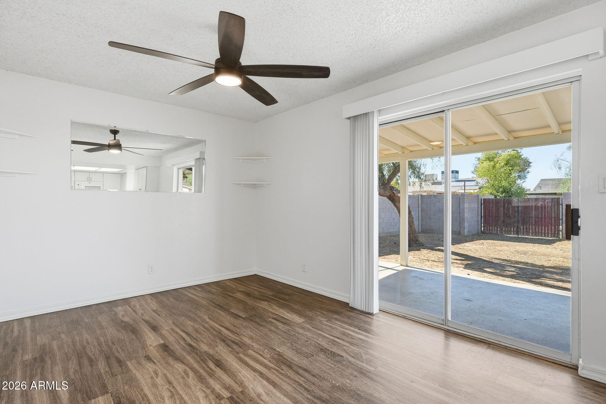 2302 East Nisbet Road Phoenix, AZ 85022 - Photo 9 of 22 a view of empty room with wooden floor and fan