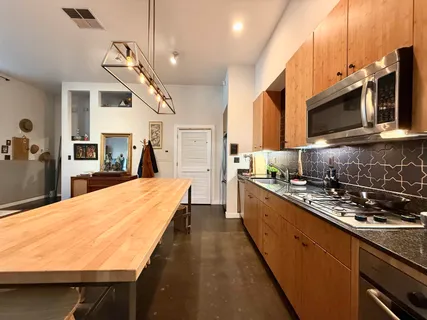 a view of a kitchen with closet and electronic appliances