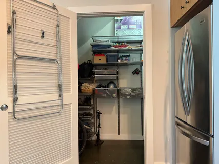 a view of a storage and utility room with washer and dryer