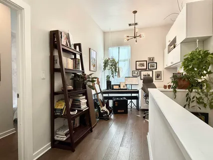 a view of a workspace with furniture and a potted plant