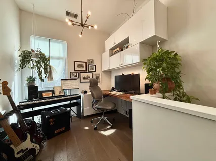 a view of a workspace with furniture and a potted plant