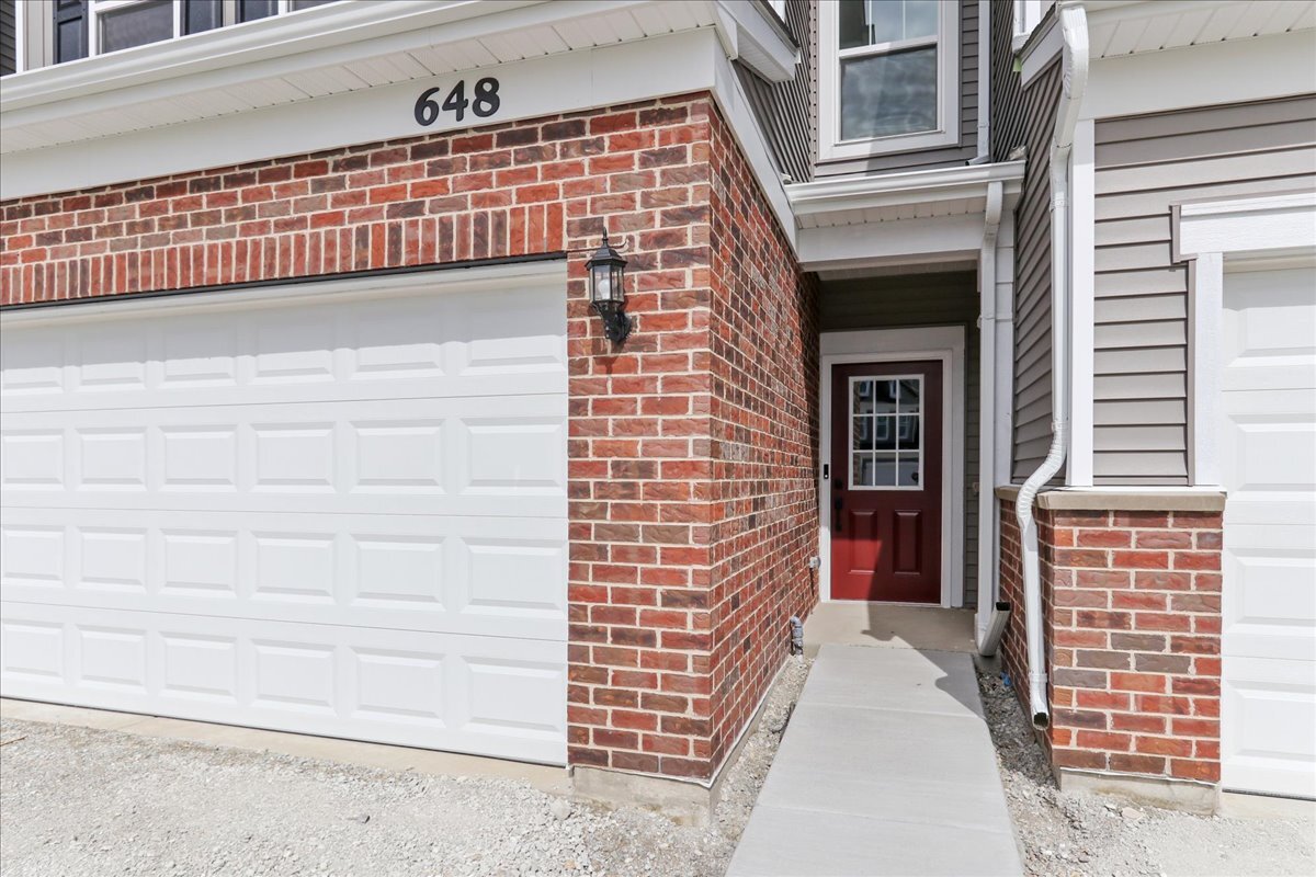 656 Switchgrass Way, Unit 58001 Bolingbrook, IL 60490 - Photo 2 of 30 a view of front door of house